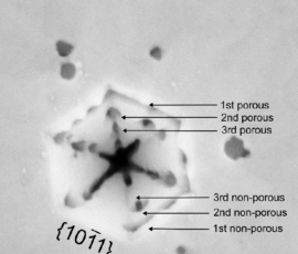 Magnified In-beam SEM image of V-pit at porous InGaN sample. Arrows indicate the layers (n-doped) in which the etching occurs.